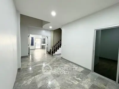 Spacious modern interior with marble flooring and staircase, perfect for stylish living.