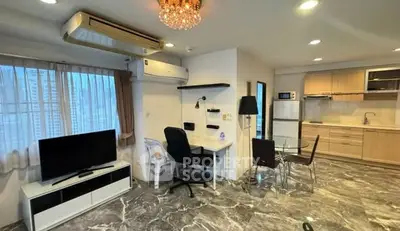 Modern open-layout living room with stylish kitchen and marble flooring in a chic apartment.