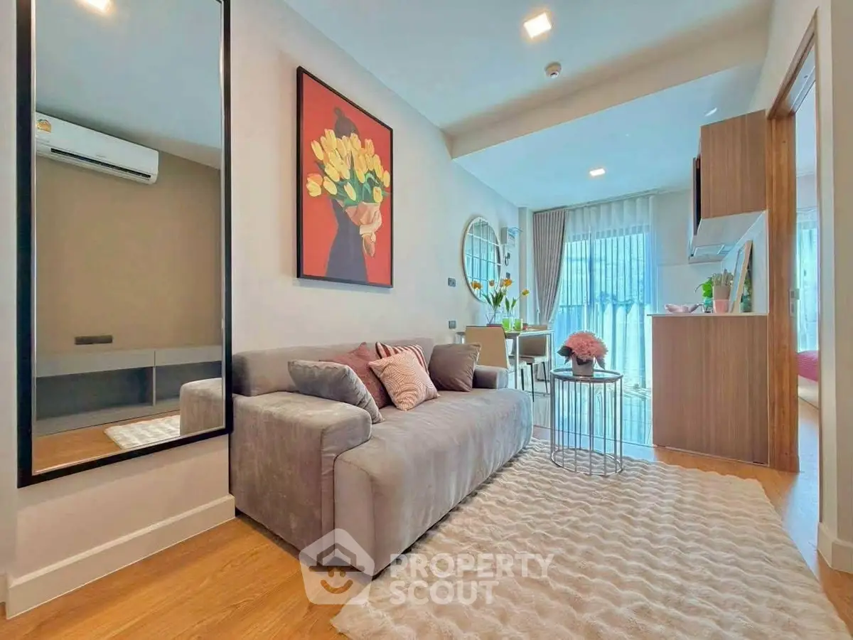 Modern living room with stylish decor and open kitchen layout in a cozy apartment.