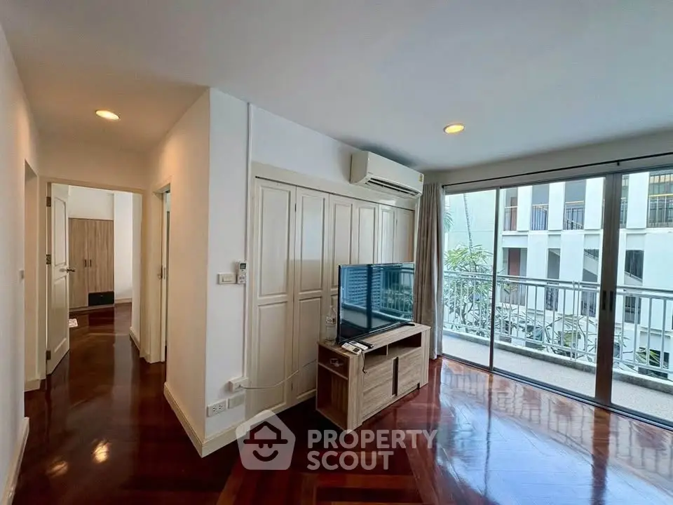 Spacious living room with balcony and modern decor in a stylish apartment.