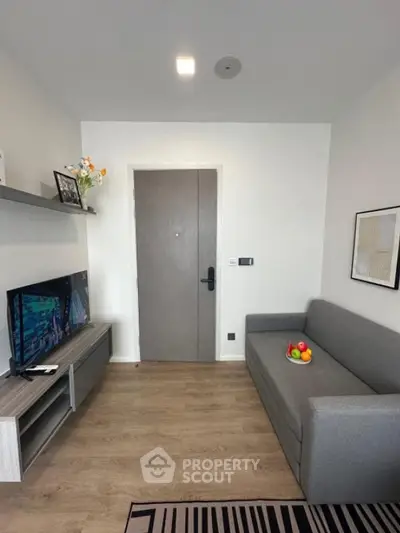 Modern living room with sleek gray sofa and stylish decor