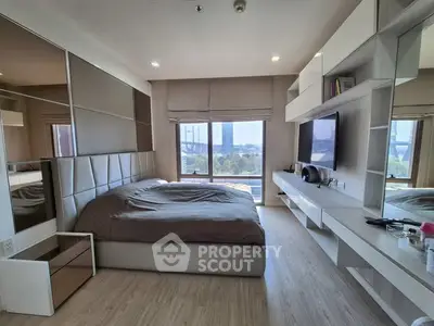 Luxurious modern bedroom with sleek design and large window offering stunning city views.