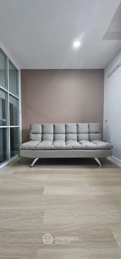 Modern living room with sleek sofa and wooden flooring