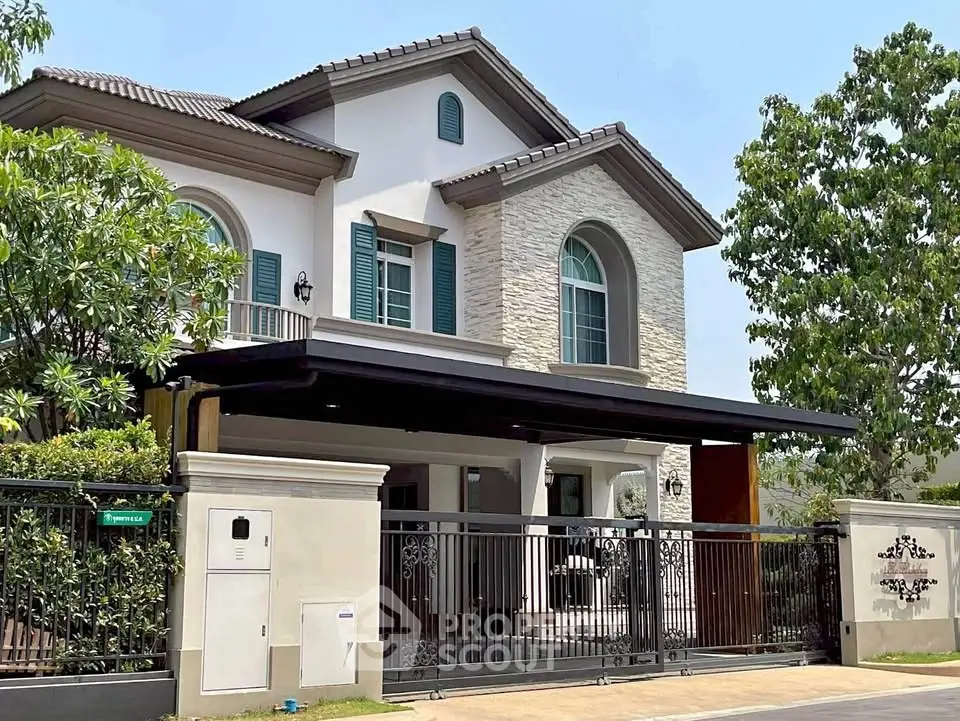Elegant two-story house with modern facade and lush greenery, perfect for family living.