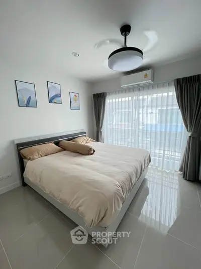 Modern bedroom with large window and stylish decor