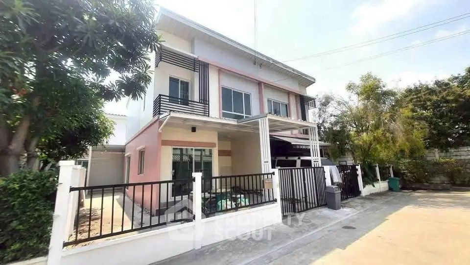 Charming two-story house with modern design and spacious outdoor area in a serene neighborhood.