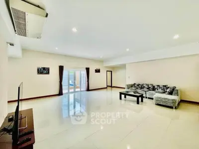 Spacious modern living room with large windows and elegant decor