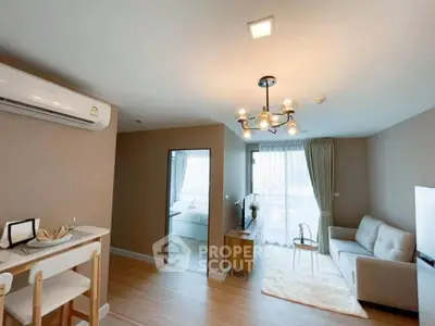 Modern living room with stylish lighting, cozy sofa, and open layout dining area in a contemporary apartment.