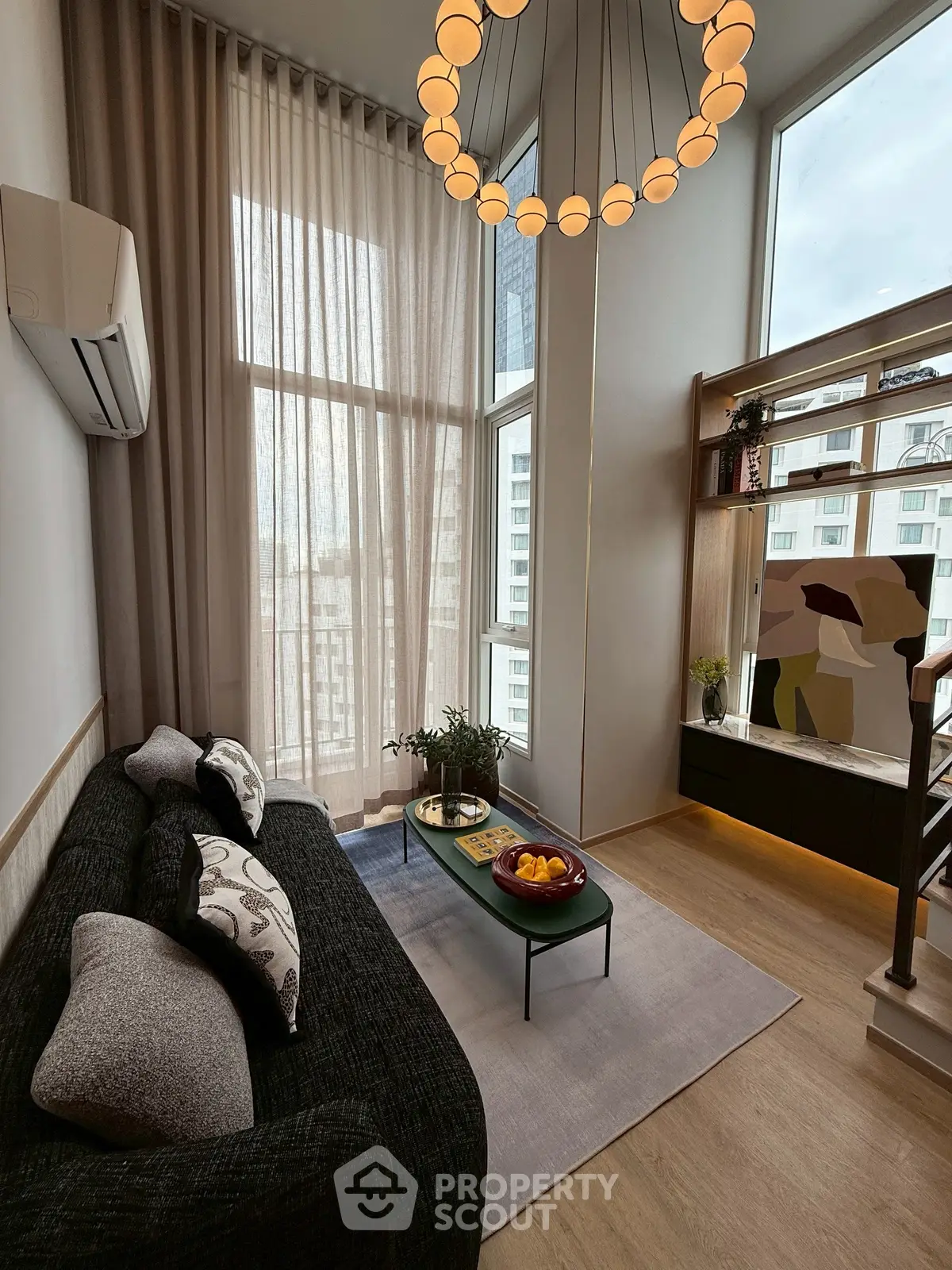 Modern living room with high ceilings, large windows, and stylish decor in a luxury apartment.
