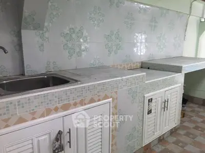Charming kitchen with vintage tile backsplash and ample counter space.