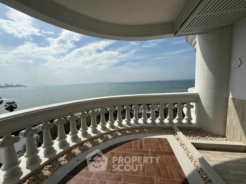 Stunning ocean view from a spacious balcony with elegant railing and tiled flooring.