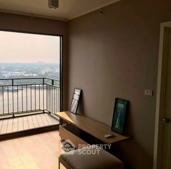 Modern living room with stunning city view and spacious balcony access.