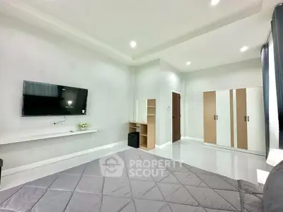 Spacious modern bedroom with sleek design and ample storage in a contemporary apartment.