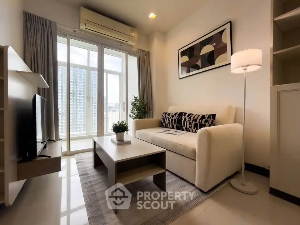 Modern living room with large window and stylish decor in urban apartment.