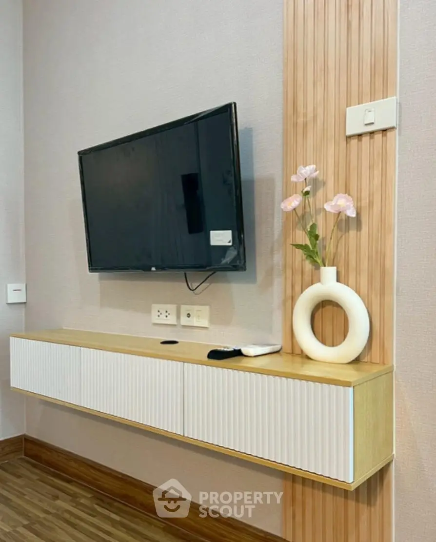 Modern living room with wall-mounted TV and stylish decor