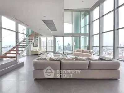 Luxurious penthouse living room with panoramic city views and modern design.