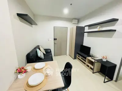 Modern living room with sleek furniture and dining area in a stylish apartment.