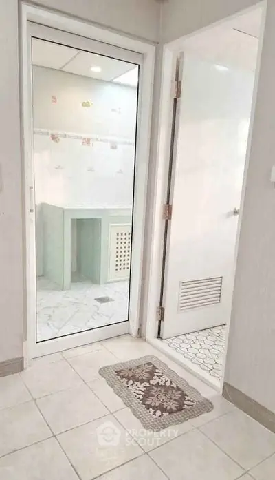 Modern bathroom with glass door and stylish tile flooring