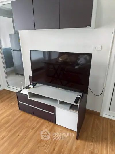 Modern living room with sleek TV stand and hardwood flooring, perfect for contemporary living.