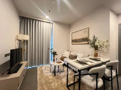 Modern living room with cozy decor and elegant dining setup in a stylish apartment.