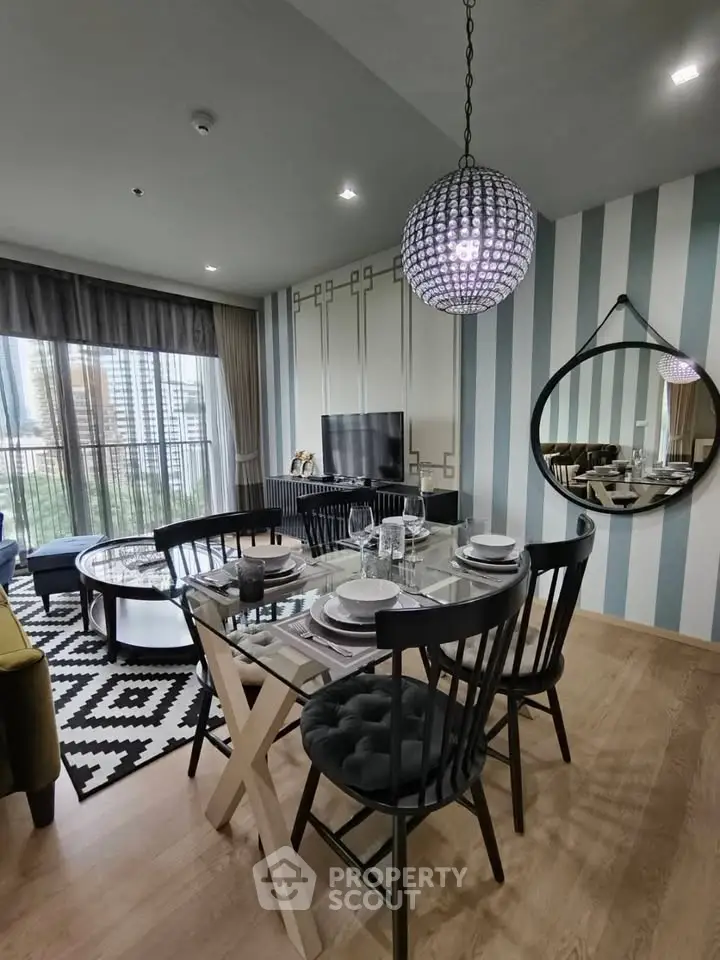 Stylish modern living room with dining area, featuring elegant decor and large windows with city view.