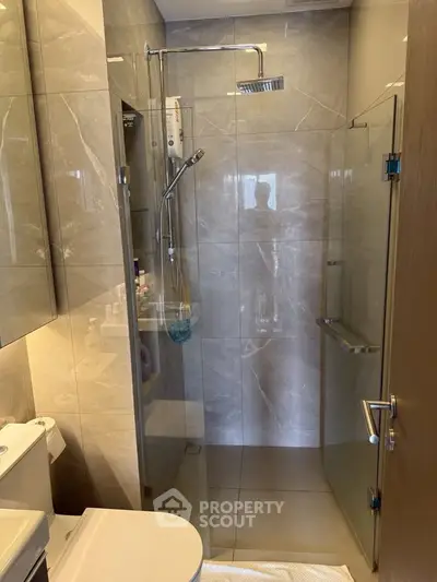 Modern bathroom with glass shower enclosure and sleek fixtures