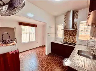 Charming kitchen with mosaic backsplash and ample natural light