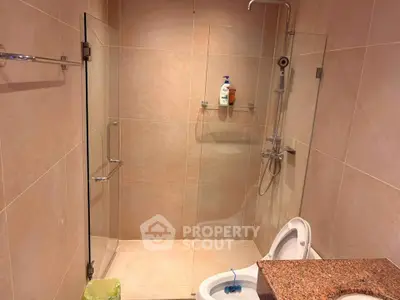 Modern bathroom with glass shower enclosure and sleek fixtures