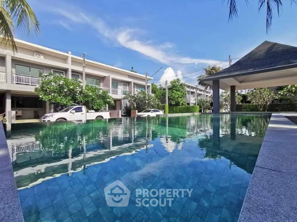 Luxurious residential complex with a stunning pool and modern architecture.