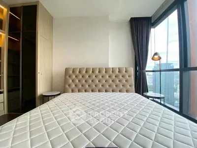 Luxurious bedroom with city view and elegant furnishings in modern apartment