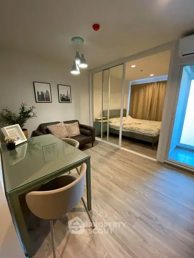 Modern apartment with open living room and bedroom, stylish decor and natural light.