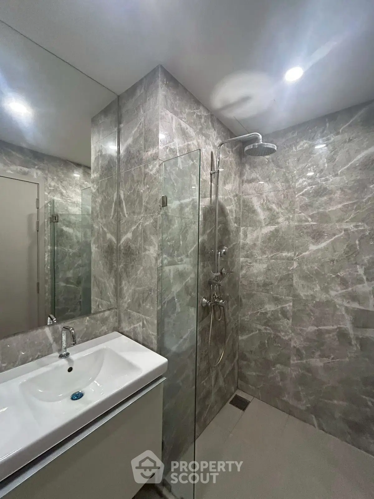 Modern bathroom with marble tiles and sleek shower design