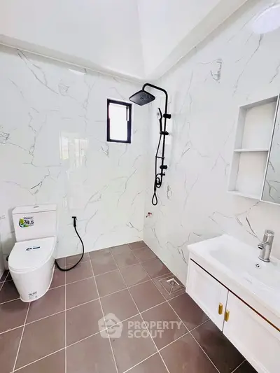 Modern bathroom with sleek shower and elegant marble tiles