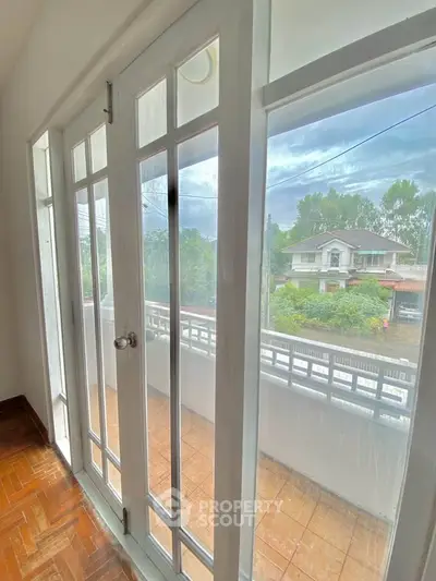 Charming balcony view with elegant French doors and scenic neighborhood