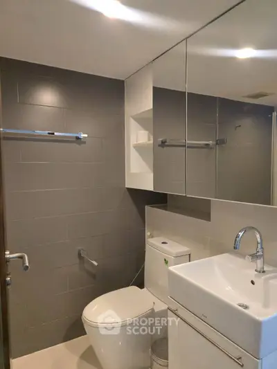 Modern bathroom with sleek fixtures and mirrored cabinets