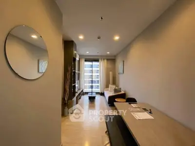 Modern living room with stylish decor and large window view in a contemporary apartment.