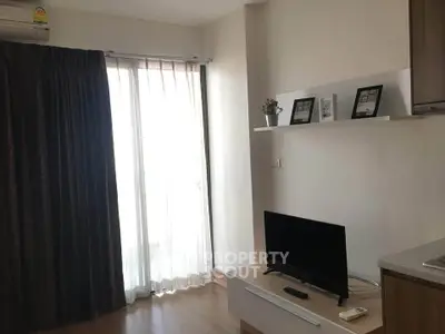 Modern living room with natural light and stylish decor in a cozy apartment.