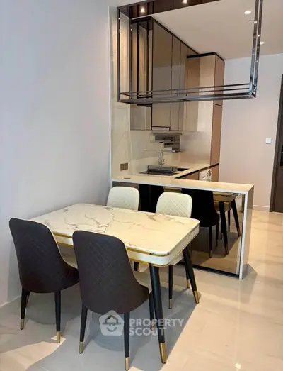 Modern kitchen with elegant dining area and sleek cabinetry in a contemporary apartment.