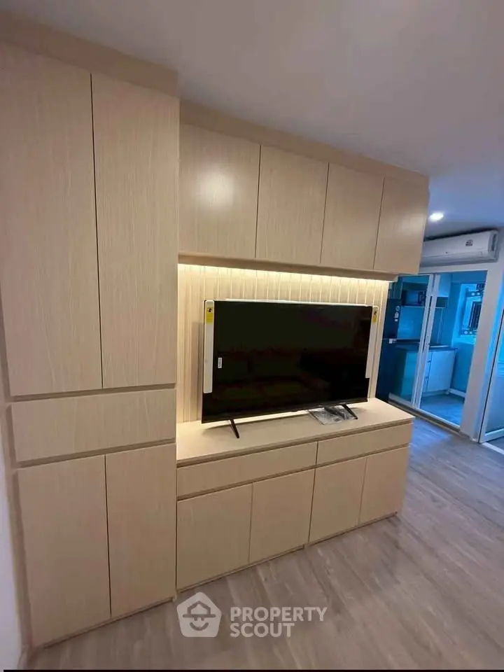 Modern living room with built-in wooden cabinets and sleek TV setup