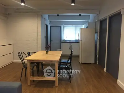 Spacious kitchen with wooden dining table and modern appliances
