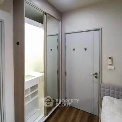 Modern bedroom with mirrored closet and wooden flooring