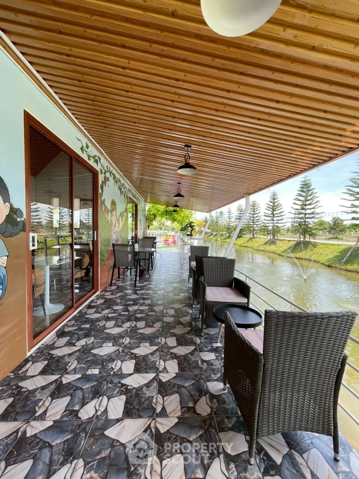 Charming outdoor balcony with scenic water view and stylish seating area.