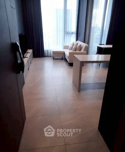 Modern living room with sleek tile flooring and cozy seating area, perfect for relaxation.