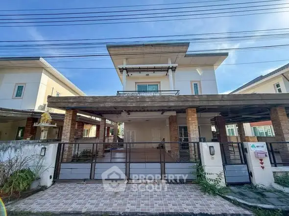 Spacious two-story house with modern design and gated entrance in a serene neighborhood.