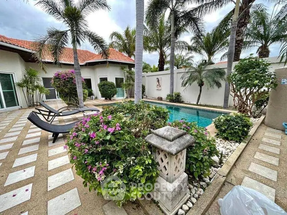 Luxurious tropical villa with private pool and lush garden, perfect for relaxation and entertaining.