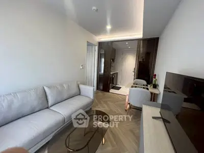 Modern living room with sleek furniture and open layout, featuring a cozy sofa and stylish decor.