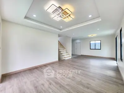 Spacious modern living room with elegant lighting and wooden flooring