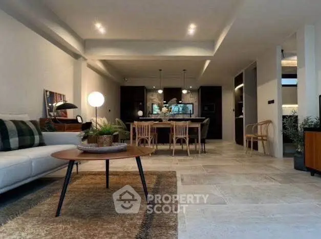 Spacious modern living room with open layout and stylish dining area, perfect for entertaining.
