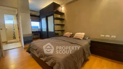 Cozy bedroom with modern decor and ample natural light