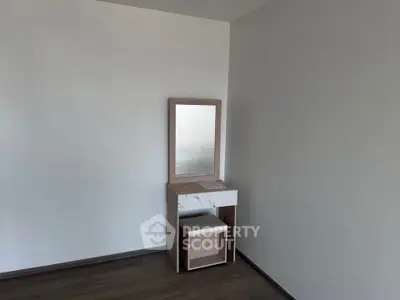 Minimalist bedroom corner with vanity table and mirror, perfect for modern living.